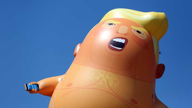 A Donald Trump balloon, floating across London